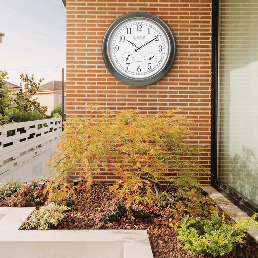 La Crosse Technology 404-00237 18-inch Atomic Outdoor Clock with Temp and Humidity hanging on the wall